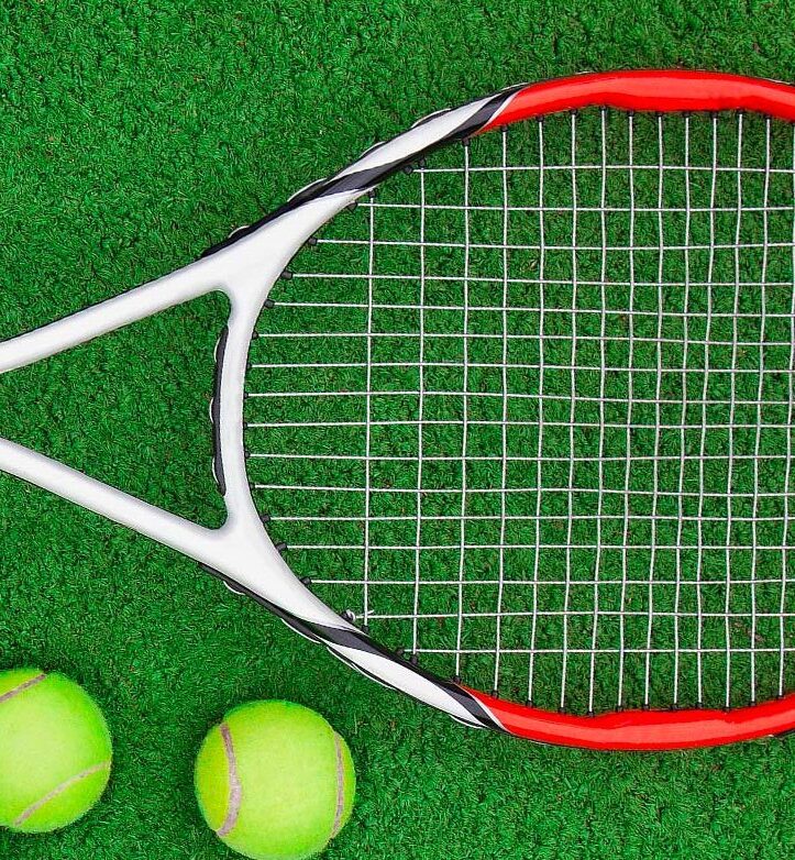 tennis racket with two tennis balls