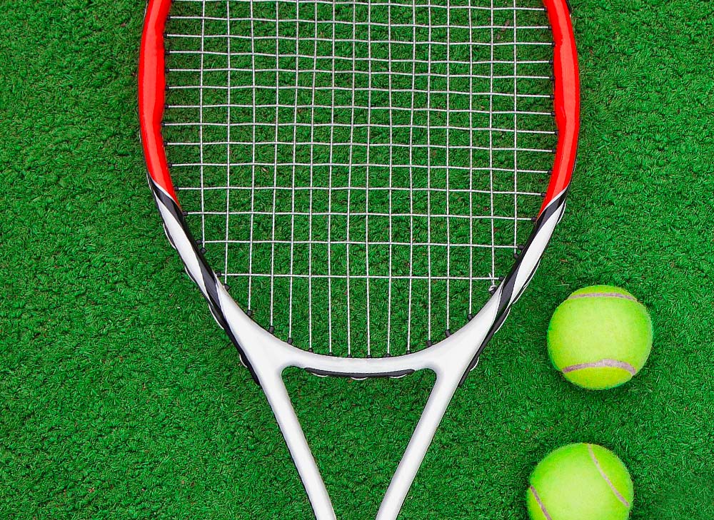 tennis racket with two tennis balls