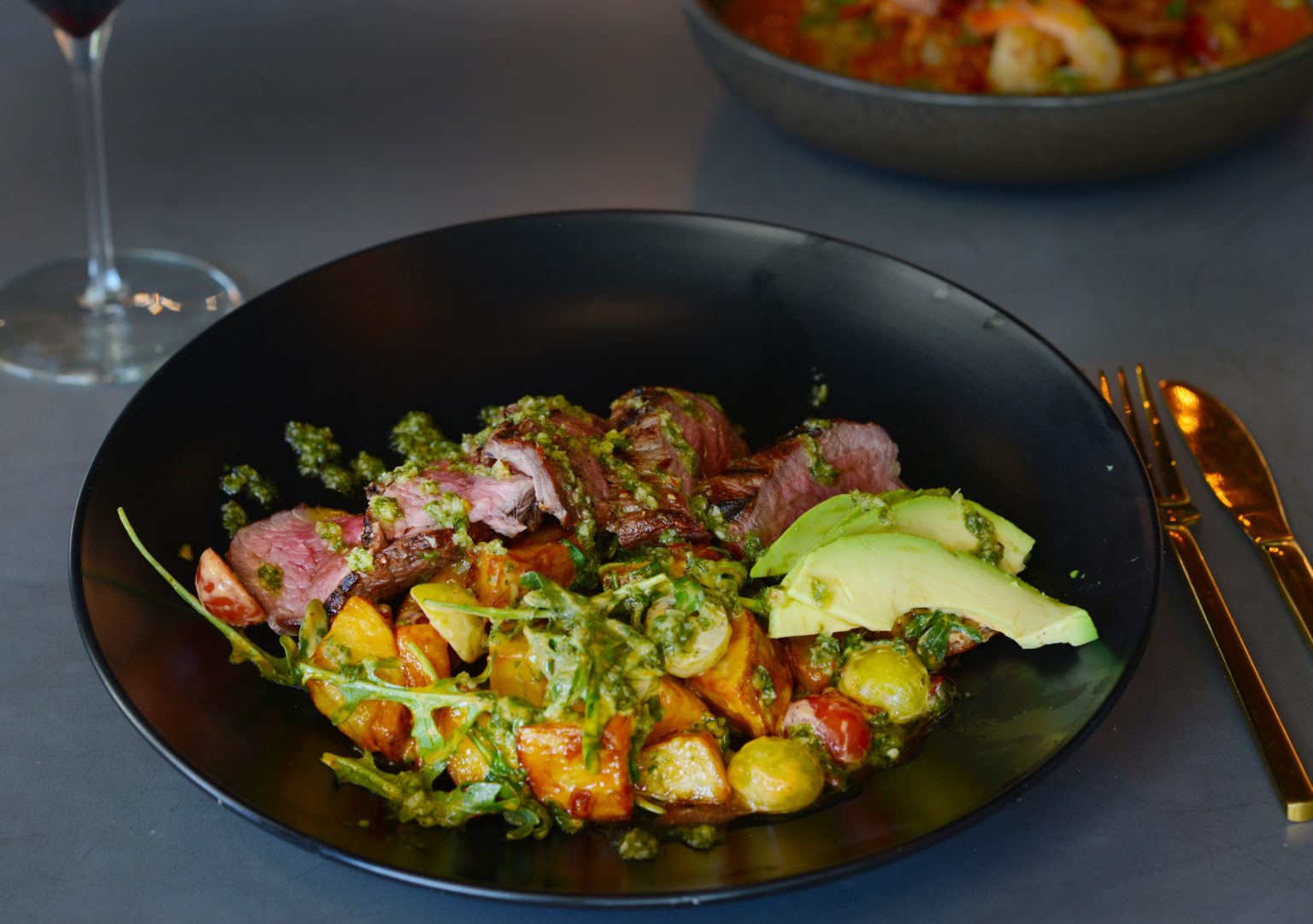 A colorful bowl of foods with a salad and protein