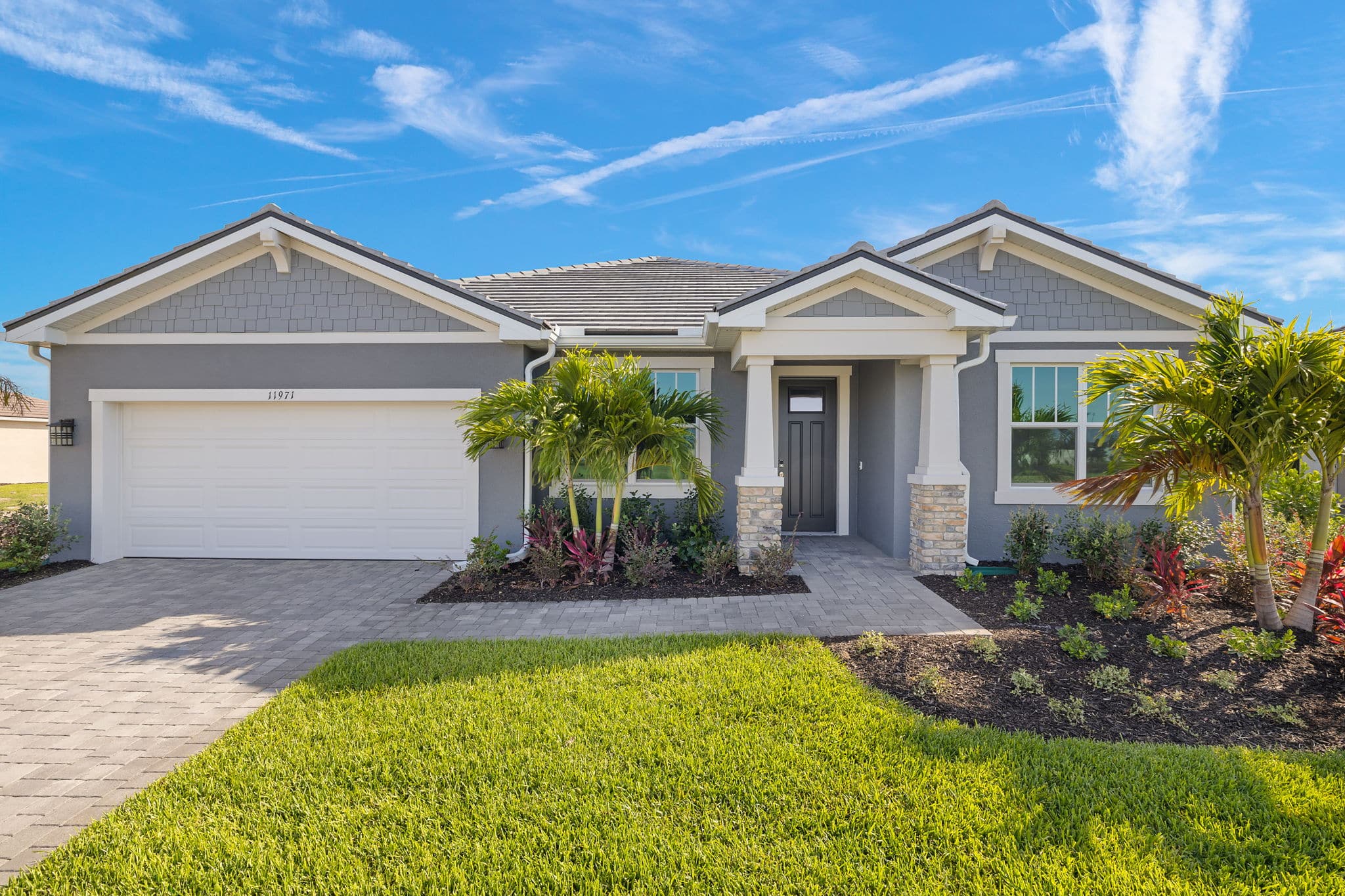 A single family house with a driveway to the garage at a Sunstone Lakeside community at Wellen Park