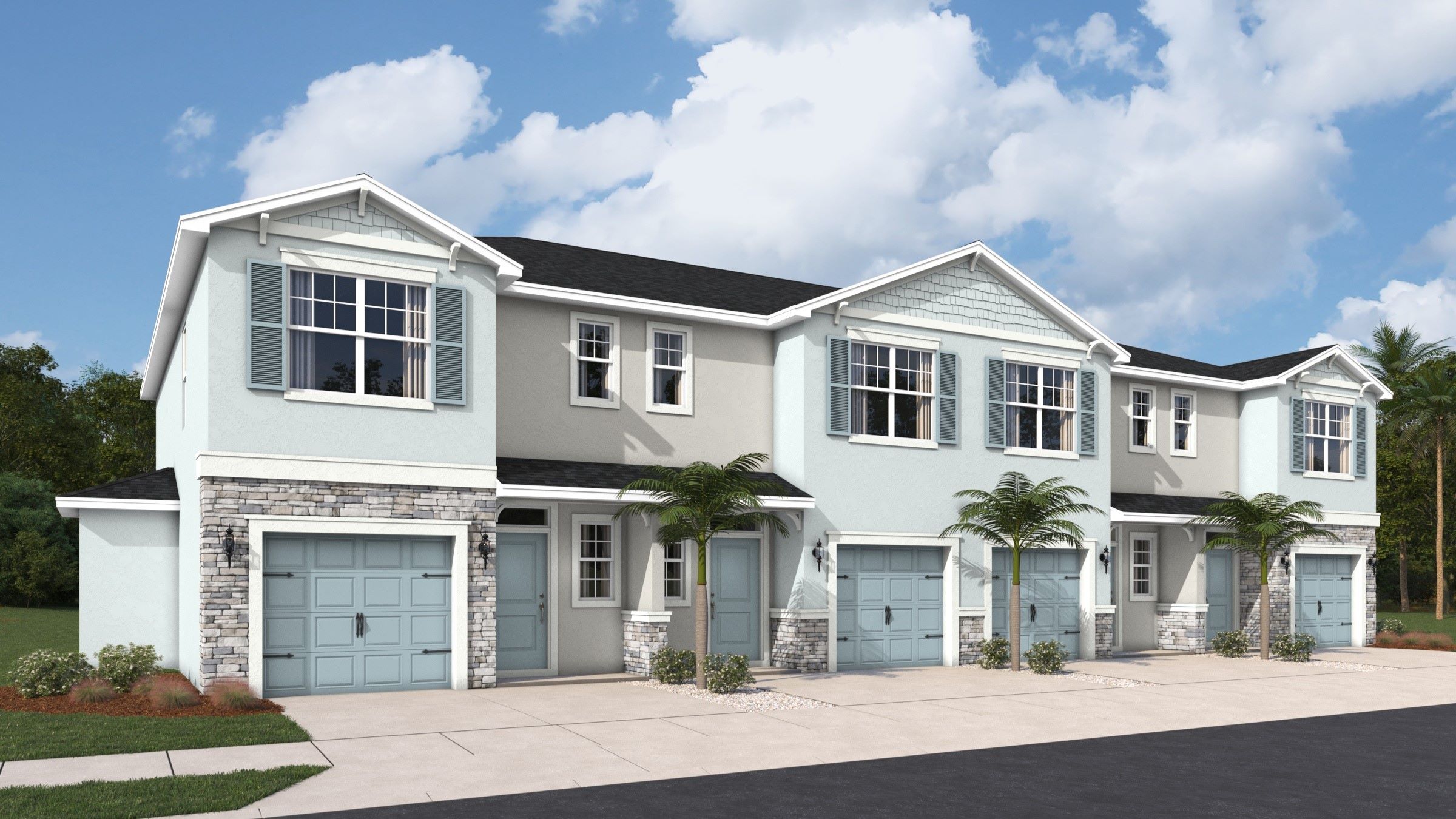 Coastal-inspired townhome exteriors featuring soft blue and neutral tones, charming shutters, and private garages, all framed by lush landscaping for a welcoming curb appeal.