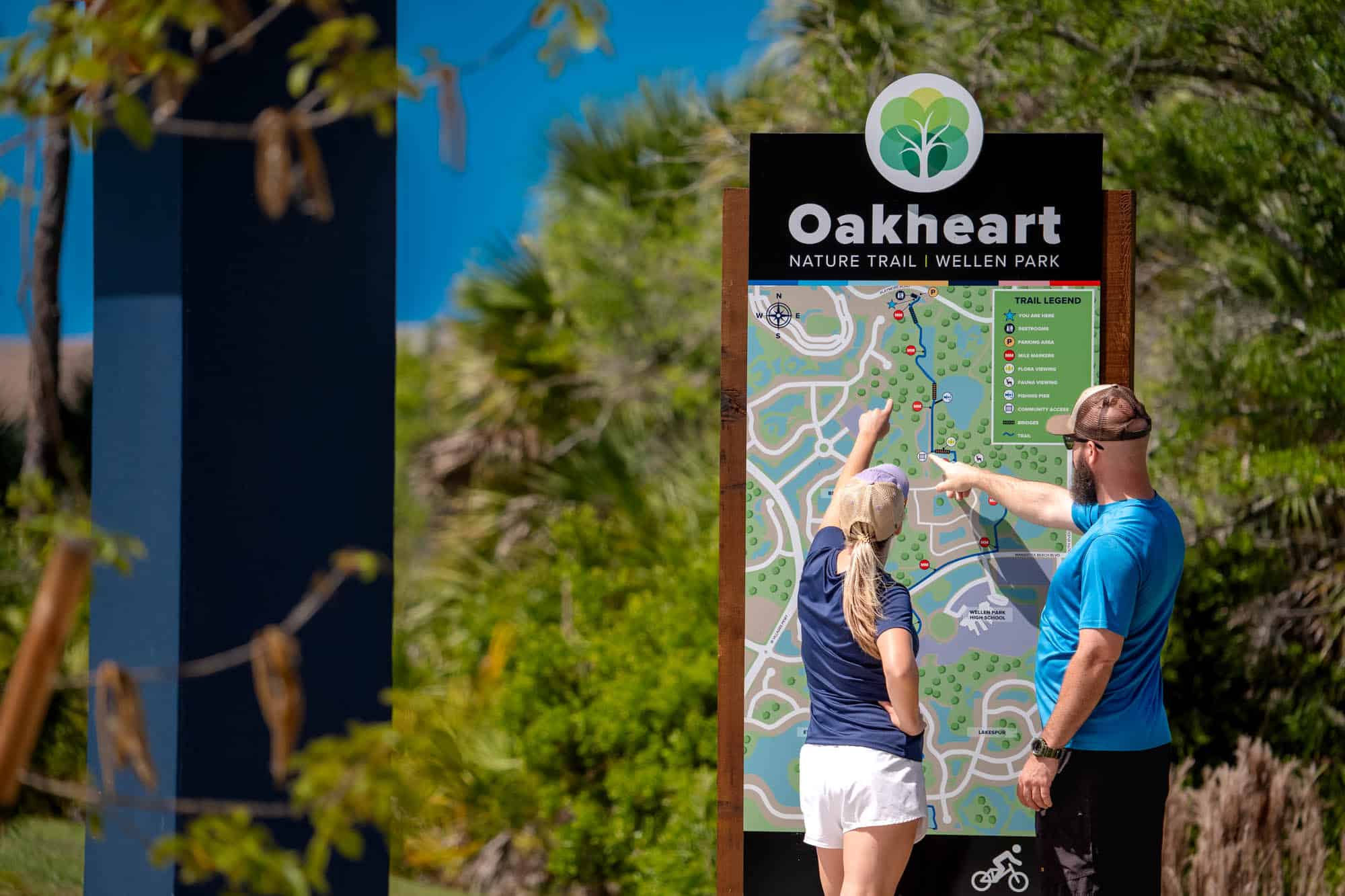 Visitors review the trail map at Oakheart Nature Trail in Wellen Park, Florida, surrounded by native landscapes, scenic nature trails, and outdoor recreation opportunities.
